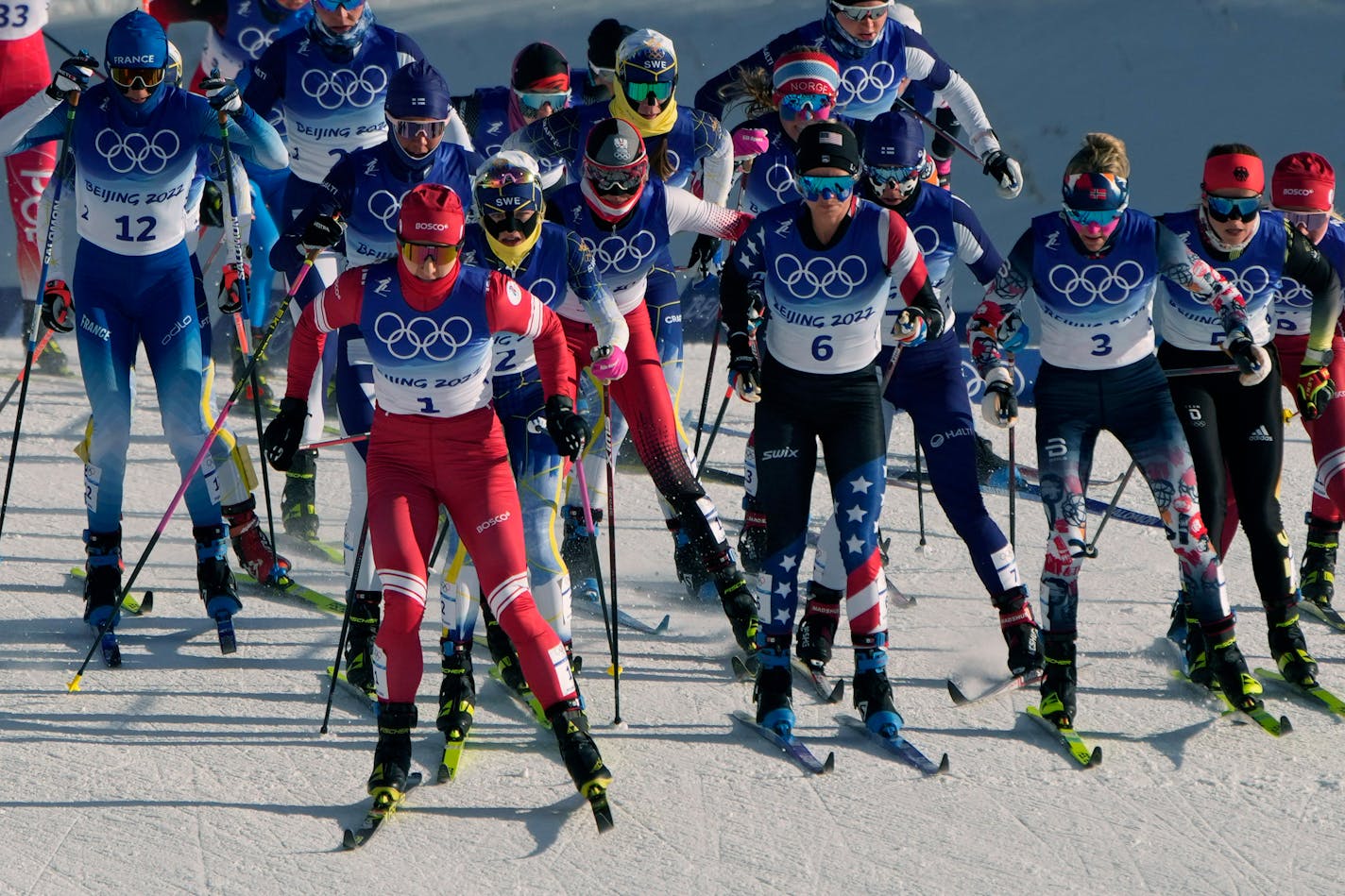 Russian athlete Natalia Nepryaeva (1) races beside United States' Jessie Diggins (6) and Norway's Therese Johaug (3) during the women's 7.5km + 7.5km Skiathlon