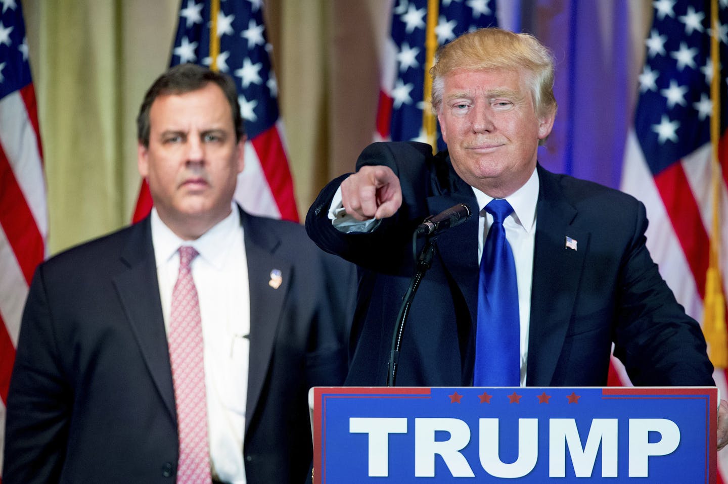 Republican presidential candidate Donald Trump, accompanied by New Jersey Gov. Chris Christie, left, takes questions from members of the media during a news conference on Super Tuesday primary election night in the White and Gold Ballroom at The Mar-A-Lago Club in Palm Beach, Fla., Tuesday, March 1, 2016. (AP Photo/Andrew Harnik) ORG XMIT: MIN2016030213164839