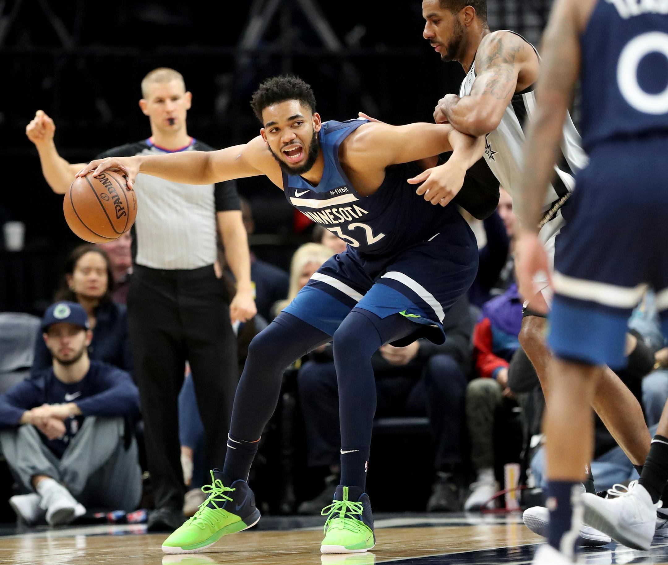 Karl-Anthony Towns drives against the San Antonio Spurs' LaMarcus Aldridge during the first half.