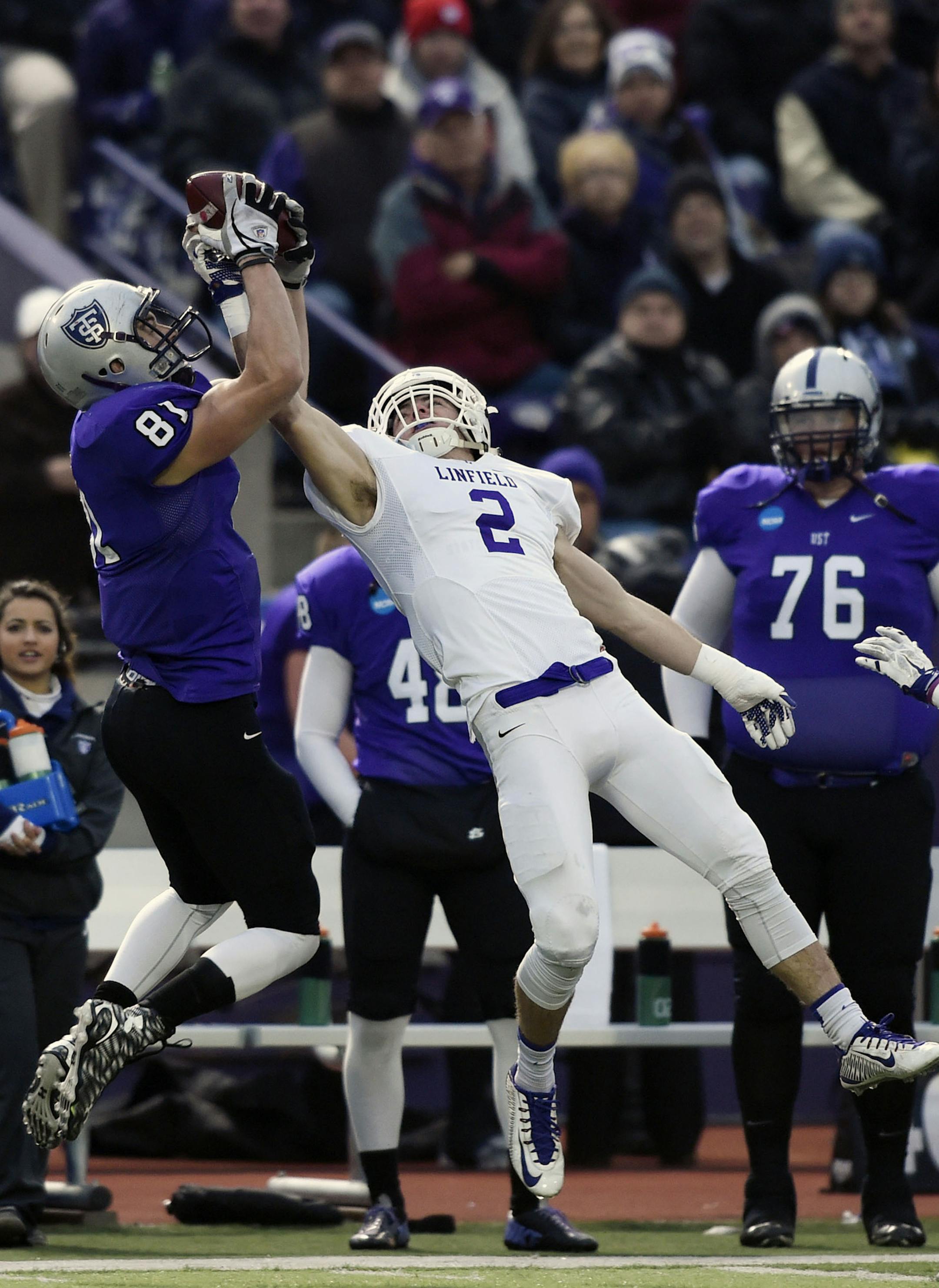 St. Thomas tight end Charlie Dowdle (81) makes a catch against Linfield cornerback Dylan Lewis (2) during the second quarter of a Division III NCAA college football semifinal game on Saturday, Dec. 12, 2015, in St. Paul, Minn. (AP Photo/Hannah Foslien)