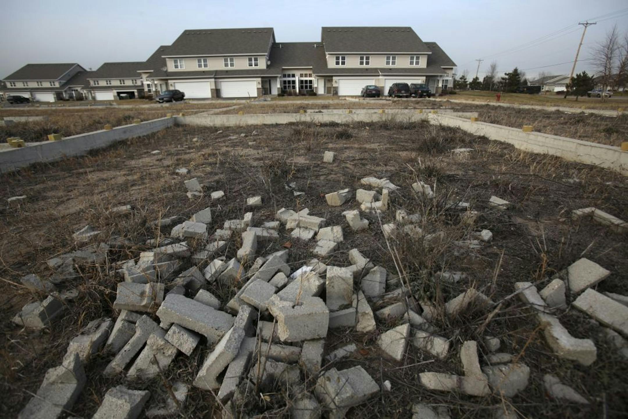 Broken concrete was left in these lots that should have been town homes at Mississippi Dunes Estates in Cottage Grove , Min., Friday, December 16, 2011.