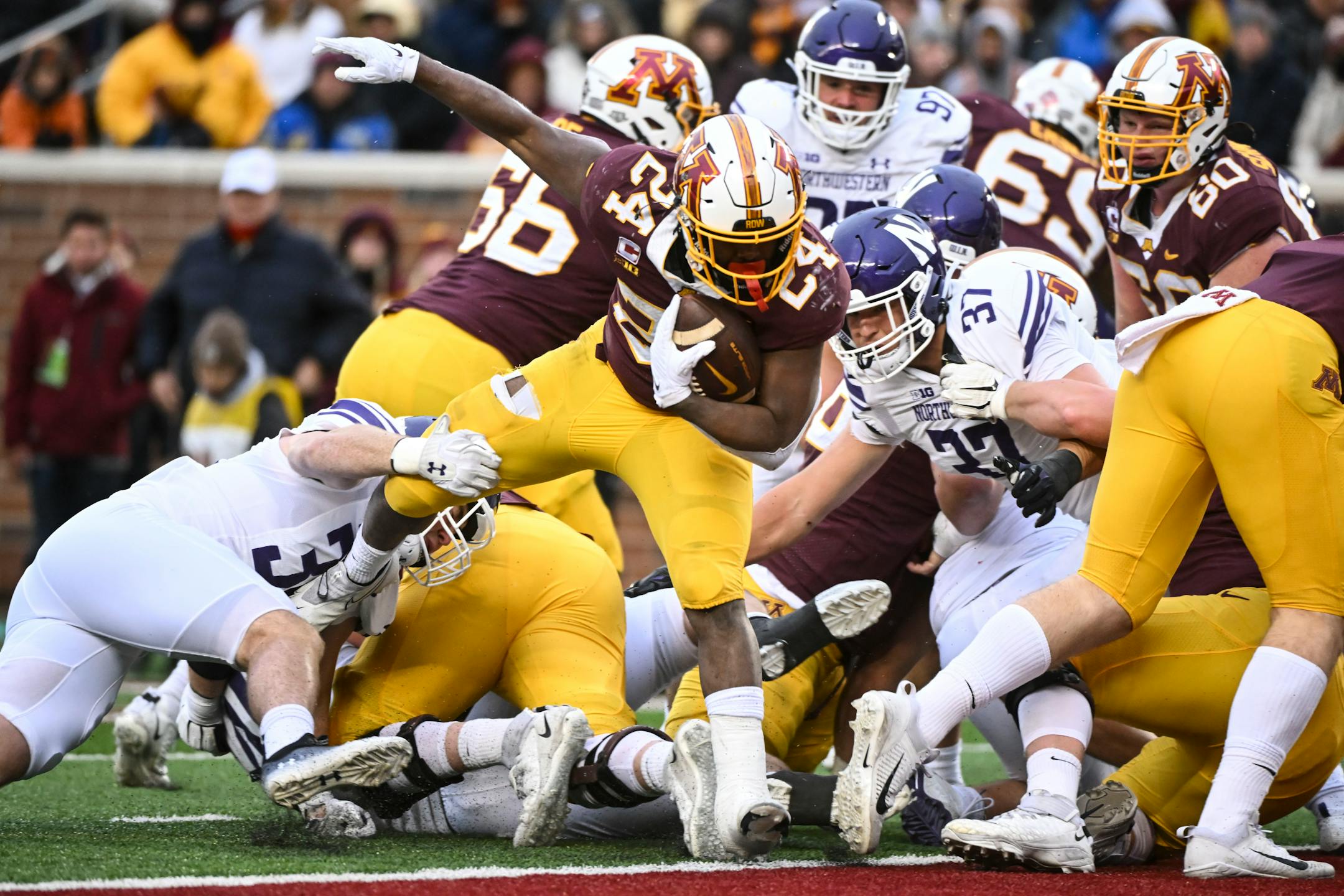 Minnesota Gophers running back Mohamed Ibrahim (24) scores his second touchdown of the game during the first half.