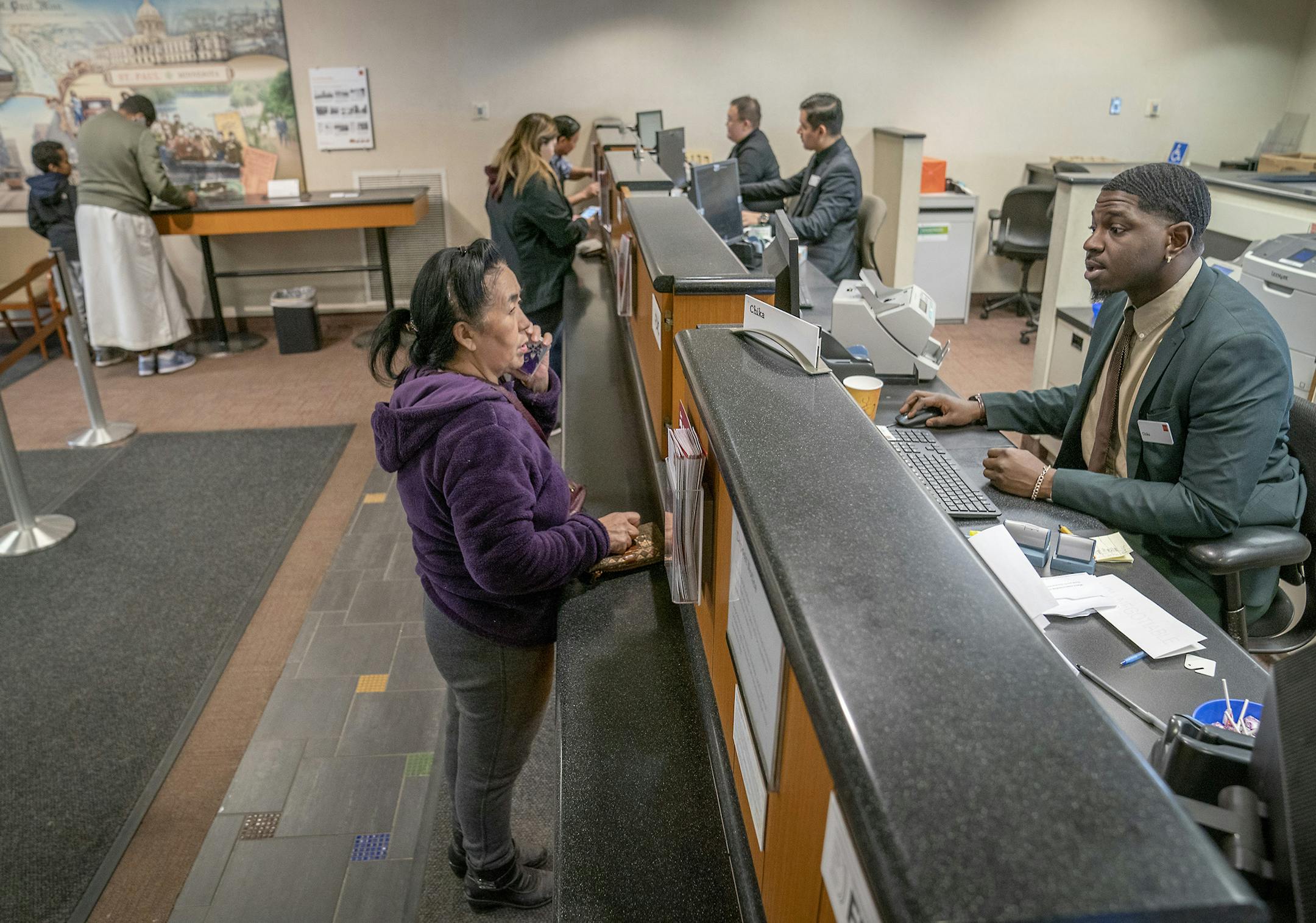 Chika Aghenu, cq, a teller from Africa, worked with customers, at the Prosperity Wells Fargo branch, Friday, January 11, 2019. The branch, on the East Side of St. Paul, is one of the bank's busiest branches in the country with many of its customers being from immigrant populations and most of its bank workers speaking multiple languages. ] ELIZABETH FLORES • liz.flores@startribune.com