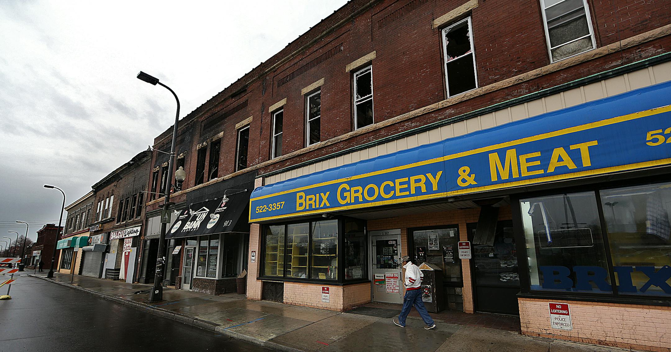 The future of a historic north Minneapolis commercial strip is uncertain more than a week after a blaze ripped through its brick walls. The city said Thursday it won't demolish the properties, leaving building owners to grapple with whether they can be saved. ] JIM GEHRZ ï james.gehrz@startribune.com / Minneapolis, MN / April 24, 2015 /12:00 PM - BACKGROUND INFORMATION: And tenants of the apartments upstairs are still reeling; two of them were hanging out behind the building one recent afte