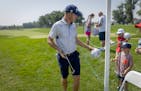 Justin Thomas signs autographs for young fans at the PGA Tour's 3M Open in Blaine, Minn., on Tuesday, July 25, 2023. ] Elizabeth Flores • liz.flores