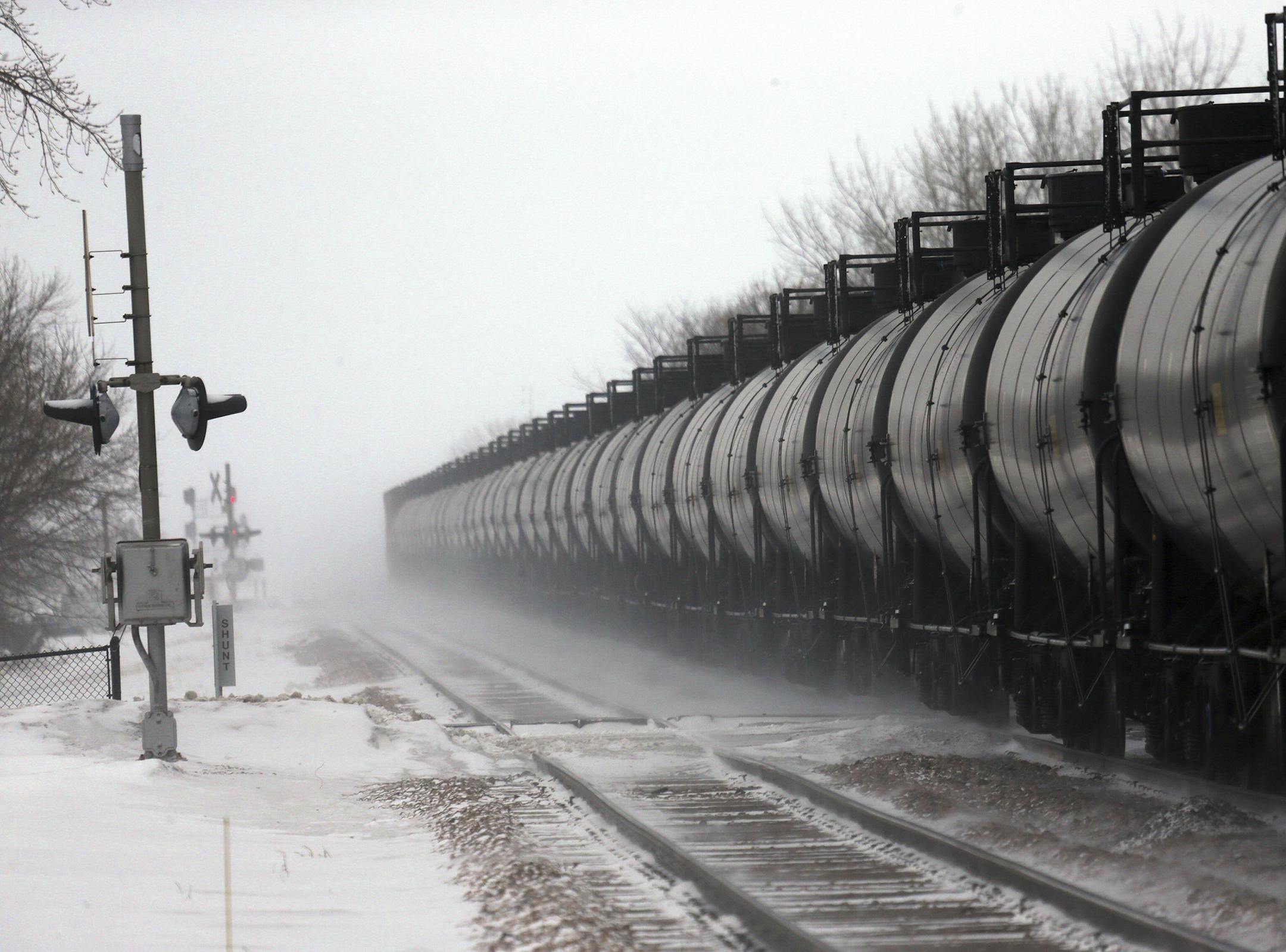 FILE -- Cars on an oil train roll through Casselton, N.D., where an explosive rail accident took place in December, Jan. 16, 2014. Responding to concerns about the safety of trains carrying oil around the country, federal regulators on Feb. 21 outlined voluntary measures for railroads to reduce the risk of rail shipments and bolster confidence in the fast-growing industry. (Jim Wilson/The New York Times)