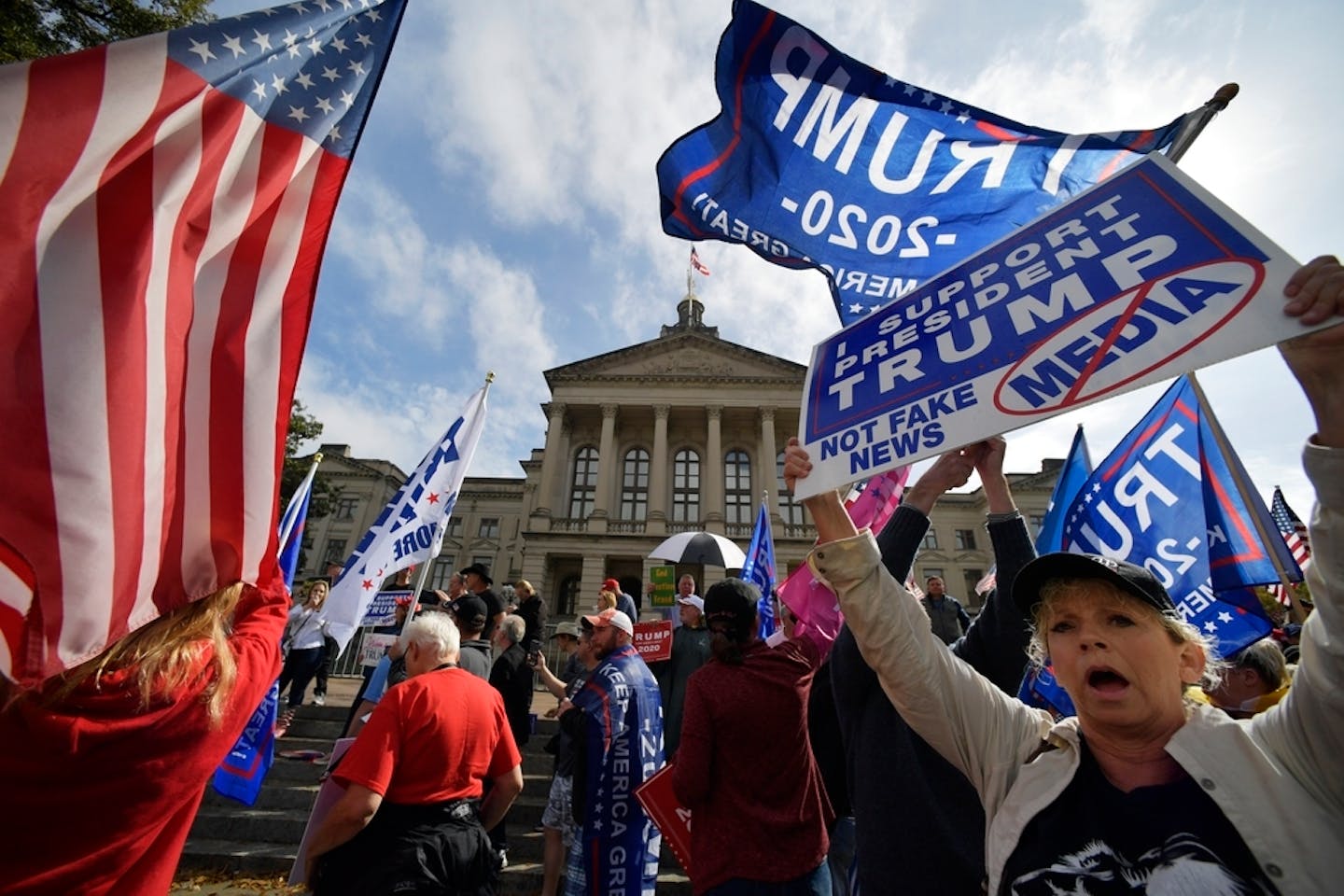 President Donald Trump supporters cheer during a rally, Saturday, Nov. 7, 2020, in Atlanta. (AP Photo/Mike Stewart)