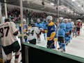 NHL players in Da Beauty League formed a tunnel for on-ice introductions of Minnesota Special Hockey players during the Unified Showcase on Monday, Au