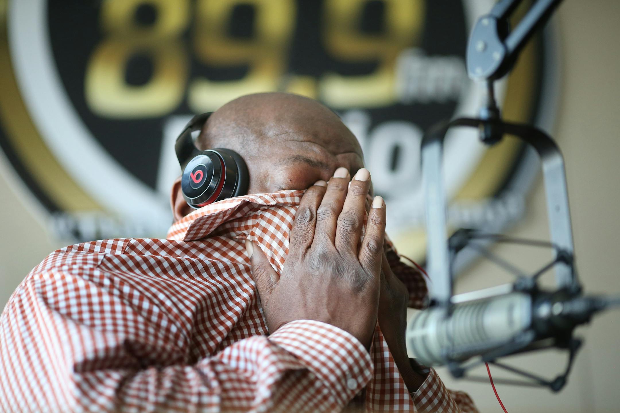 KMOJ host of afternoon drive time show Walter Q Bear Banks left cried in his hands as he talked about the death of Prince Thursday April 21, 2016 Minneapolis, MN.