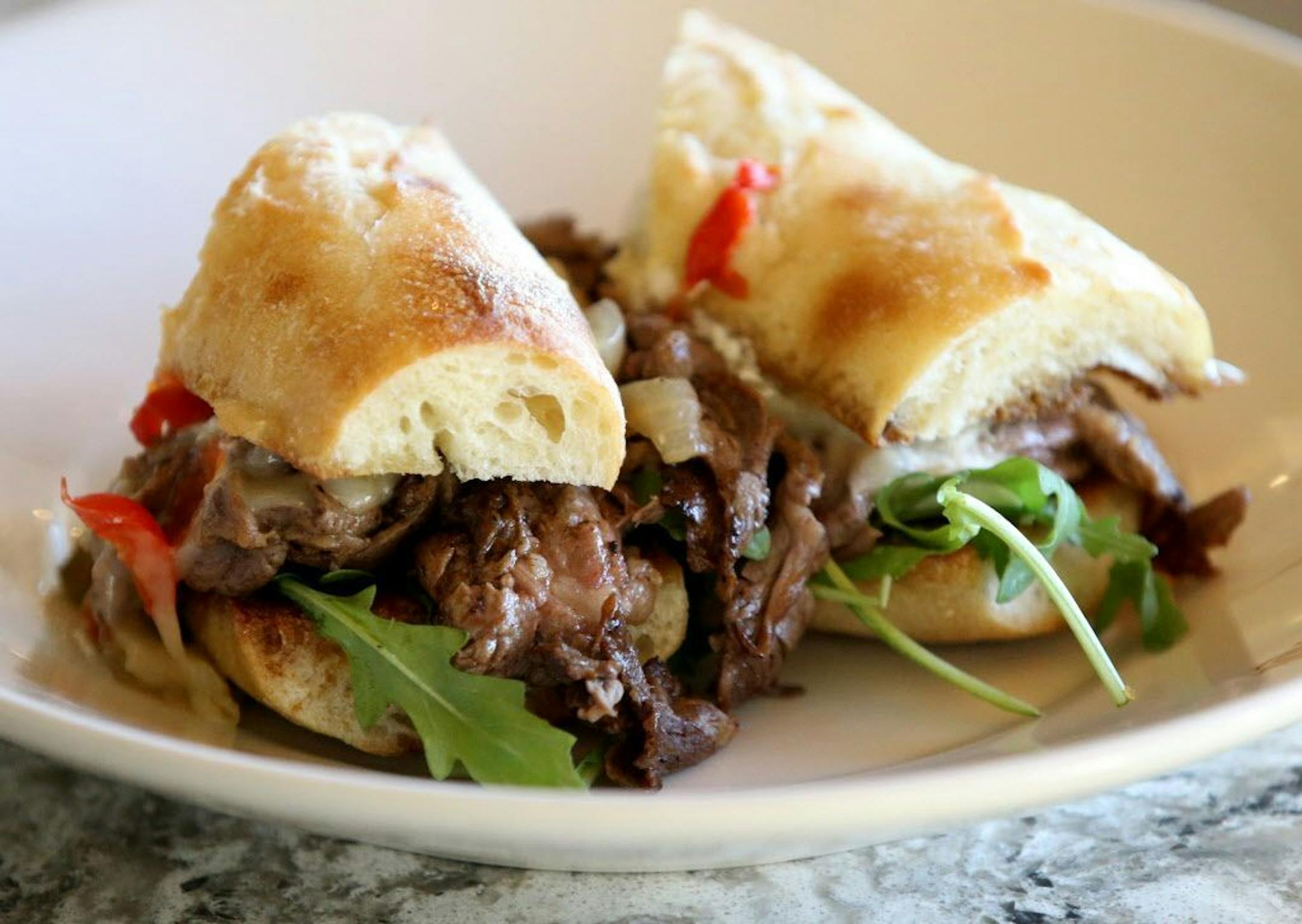 Prime rib sandwich at McKinney Roe with slow roasted prime rib, shaved and served on a toasted baguette with peppers, onions, provolone and au jus Thursday, Nov. 1, 2018, in Minneapolis, MN.