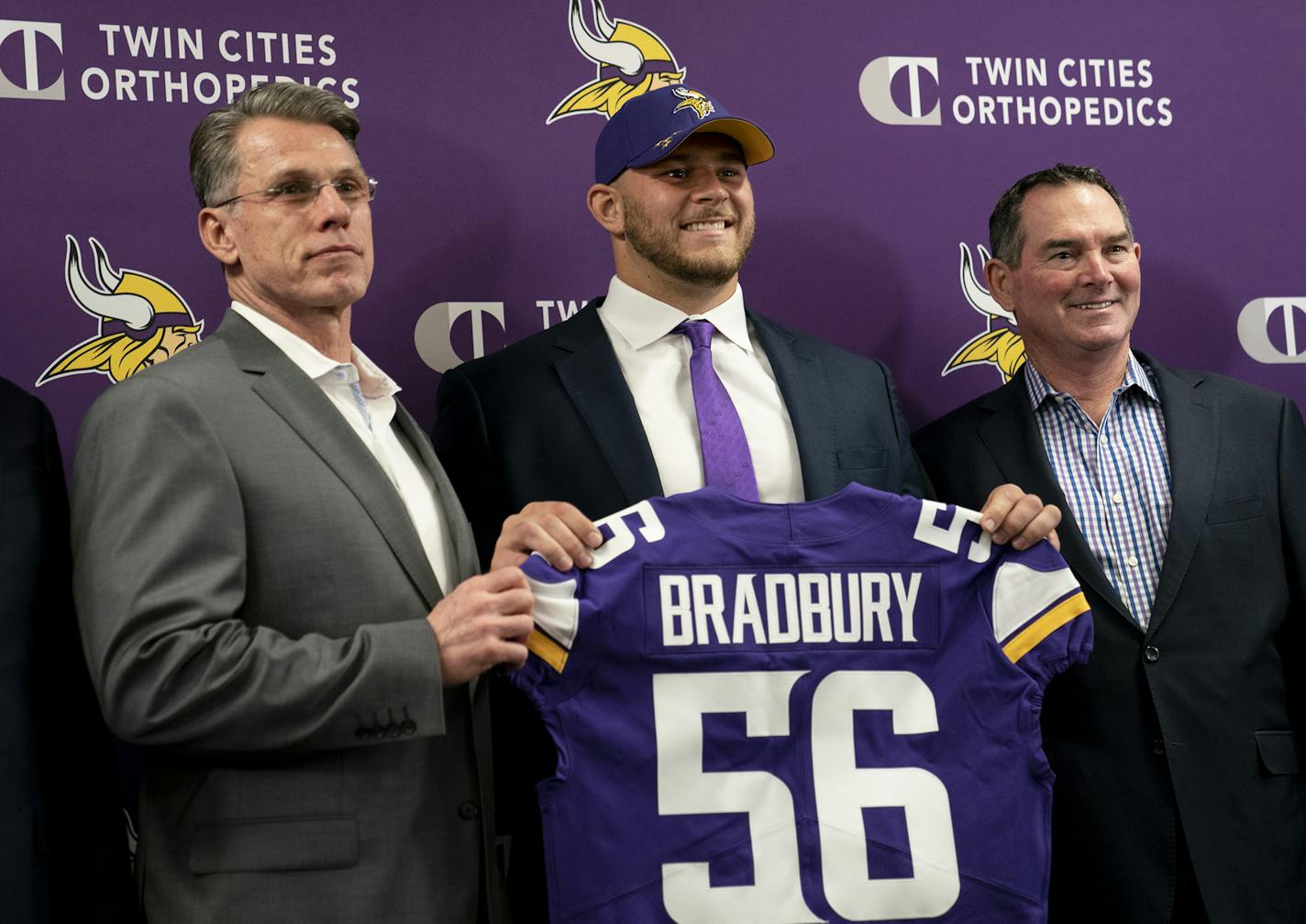 Minnesota Vikings first-round draft pick Garrett Bradbury holds his jersey with, from left, general manager Rick Spielman and head coach Mike Zimmer during a news conference at the TCO Performance Center News in Eagan, Minn., on Friday, April 26, 2019. (Renee Jones Schneider/Minneapolis Star Tribune/TNS)