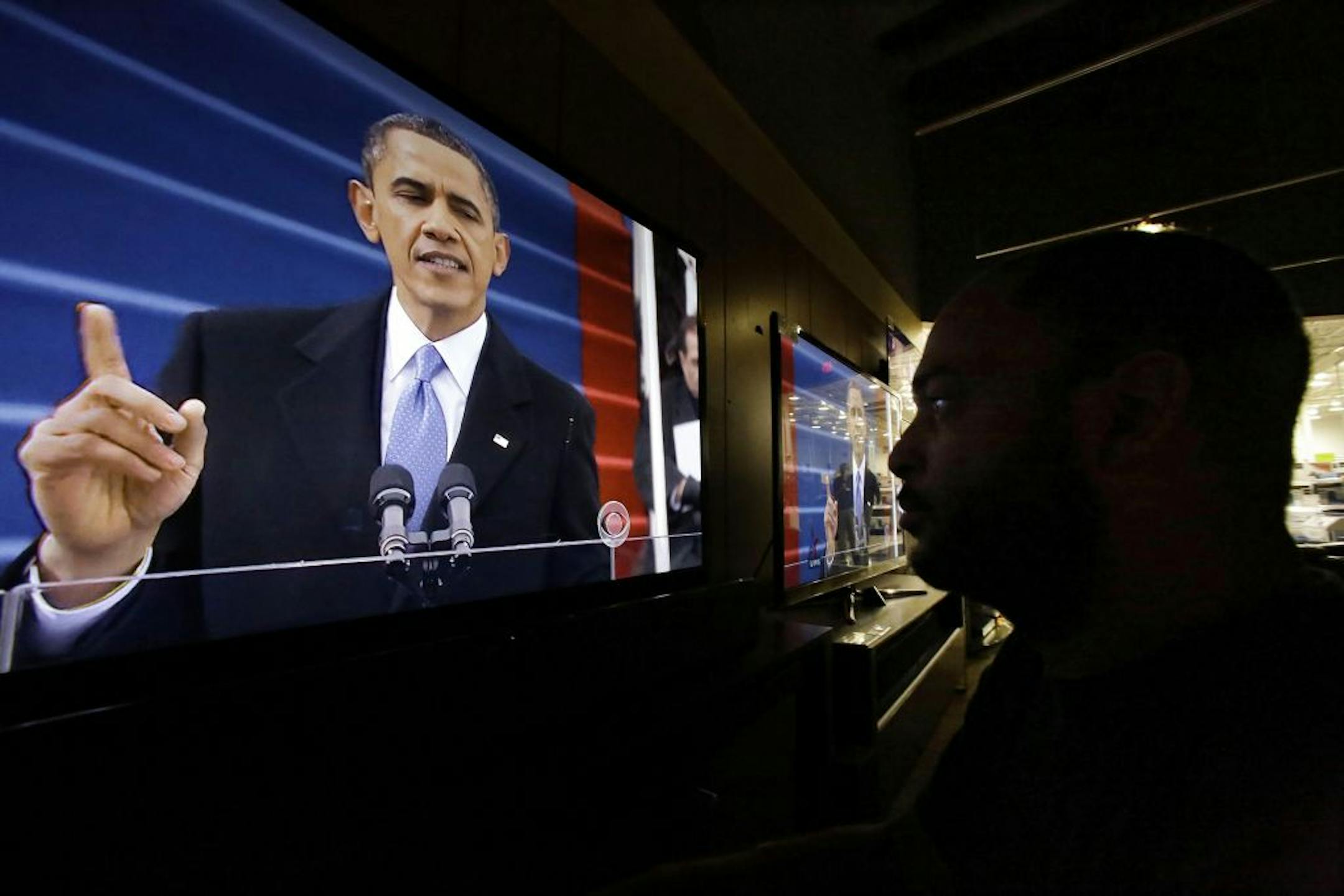 Richard Smith watches President Barack Obama deliver his inaugural address during the ceremonial swearing-in, on a television at a Best Buy department store in Springfield, Ill., Monday, Jan. 21, 2013.
