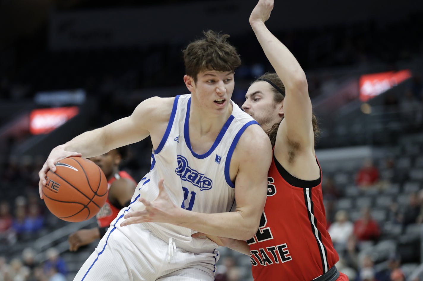 Drake's Liam Robbins, left, heads to the basket as Illinois State's Matt Chastain defends during the first half of an NCAA college basketball game in the first round of the Missouri Valley Conference men's tournament Thursday, March 5, 2020, in St. Louis. (AP Photo/Jeff Roberson) ORG XMIT: MOJR111