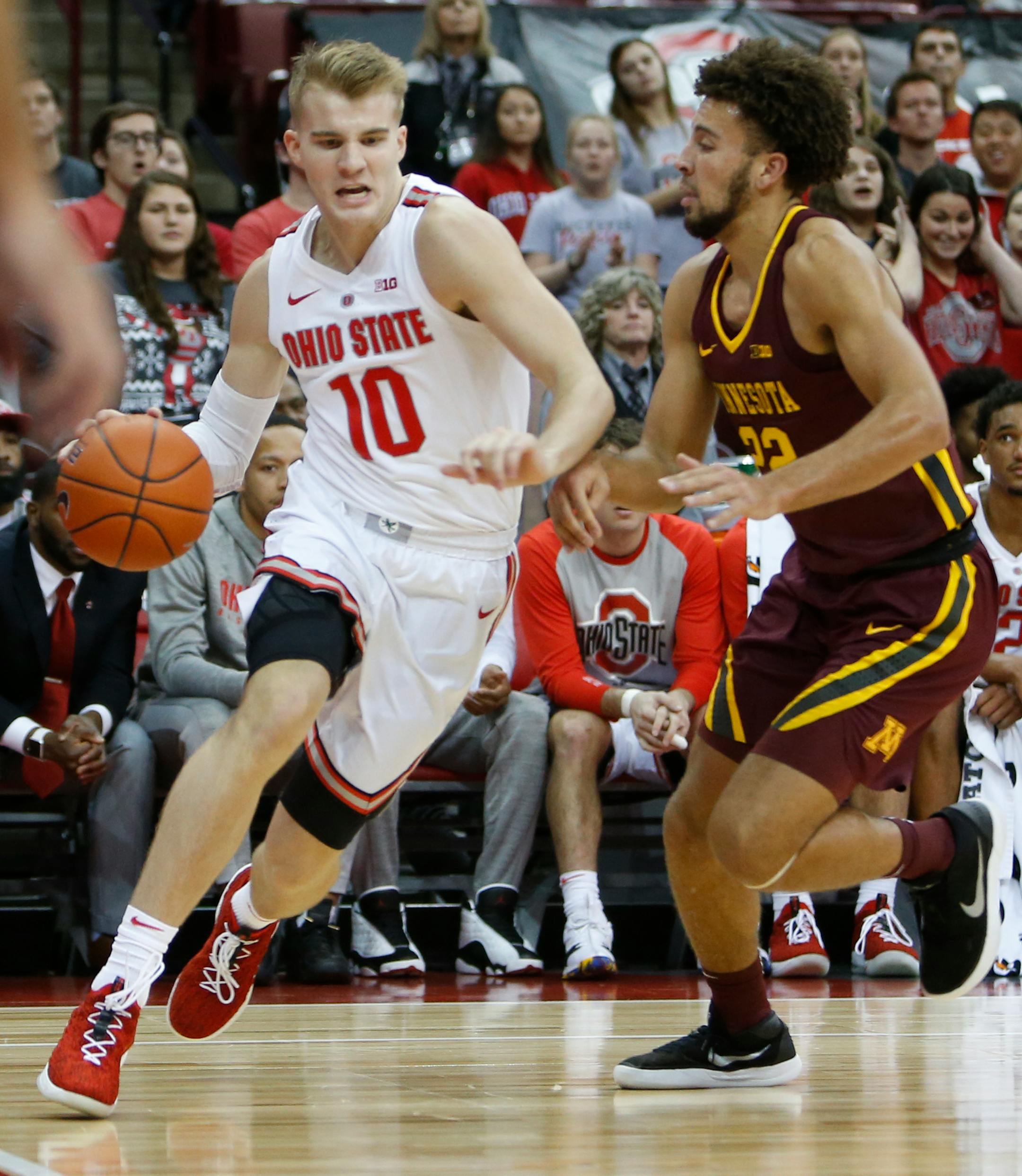 Ohio State's Justin Ahrens, left, drives the baseline against Minnesota's Gabe Kalscheur during the second half of an NCAA college basketball game Sunday, Dec. 2, 2018, in Columbus, Ohio. Ohio State beat Minnesota 79-59. (AP Photo/Jay LaPrete)