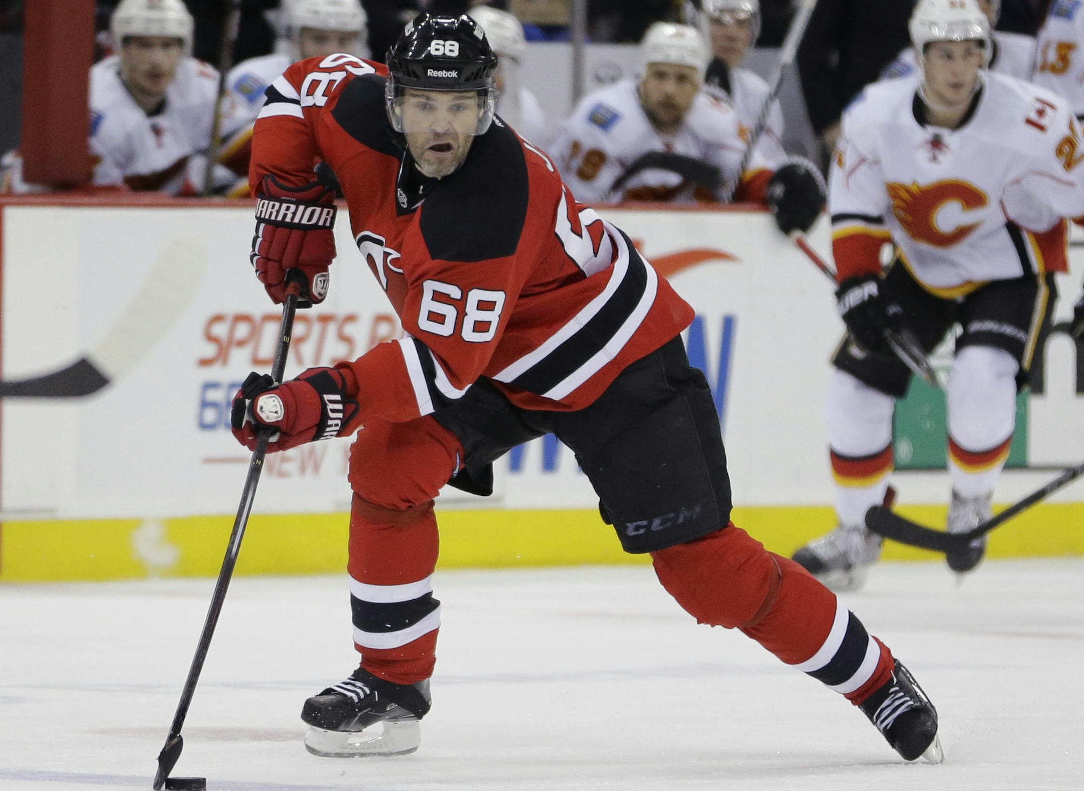 New Jersey Devils right wing Jaromir Jagr, of the Czech Republic, skates against the Calgary Flames during the second period of an NHL hockey game, Wednesday, Feb. 25, 2015, in Newark, N.J. (AP Photo/Julio Cortez)