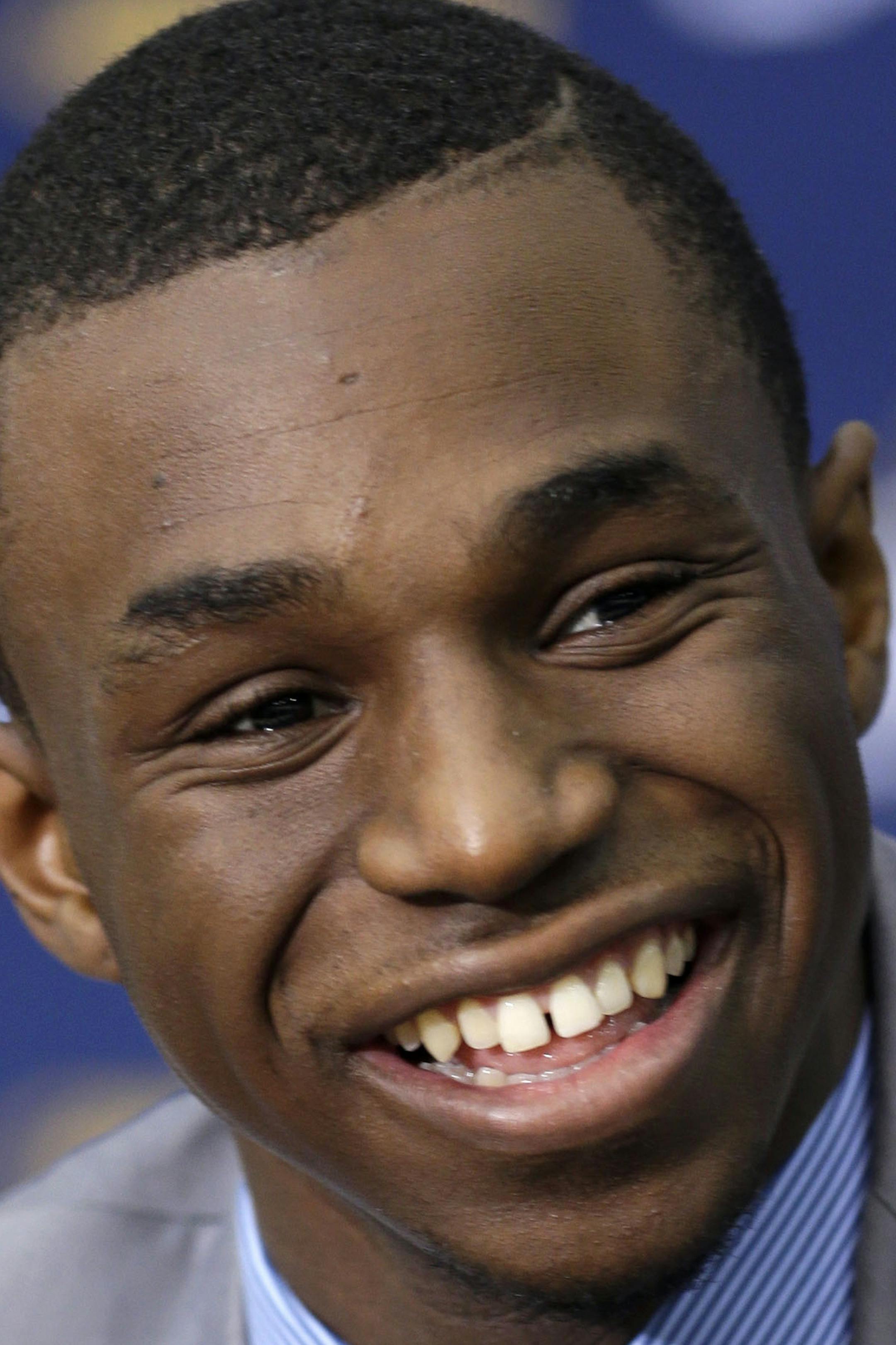 FILE - In this June 27, 2014, file photo, Andrew Wiggins, the Cleveland Cavaliers No. 1 draft pick, answers questions during an NBA basketball conference in Independence, Ohio. Wiggins will sign his rookie contract with the Cavaliers, an agreement that would prevent any potential trade involving the small forward from being completed for 30 days, a person familiar with the negotiations says. (AP Photo/Tony Dejak, File)