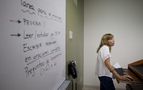In this Sept. 9, 2013 photo, University of Miami professor Francisca Aquilo-Mora works with students in her Spanish language class in Coral Gables, Fl