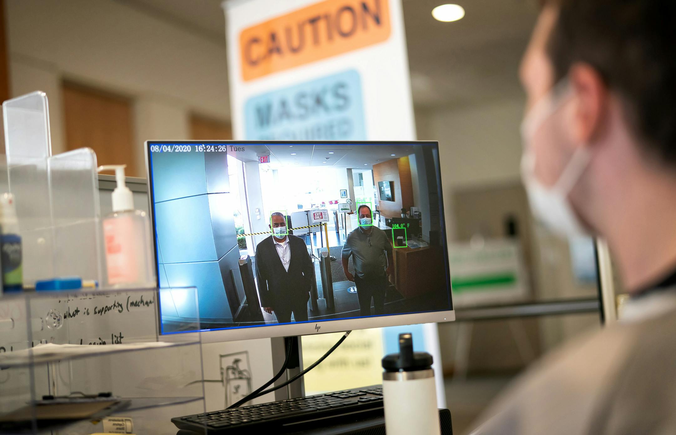 Zarir Erani president and Rick Barron founder, of VenueScreen demonstrate a system that scans the temperature of employees as they enter Boston Scientific in Minnetonka. A high speed, high definition camera uses artificial intelligence to find a subject's forehead and an infrared camera measures the temperature from that forehead. The temperature is displayed on a computer screen and monitored by a scanner operator, right. ] GLEN STUBBE • glen.stubbe@startribune.com Tuesday, August 4, 2020 A cou