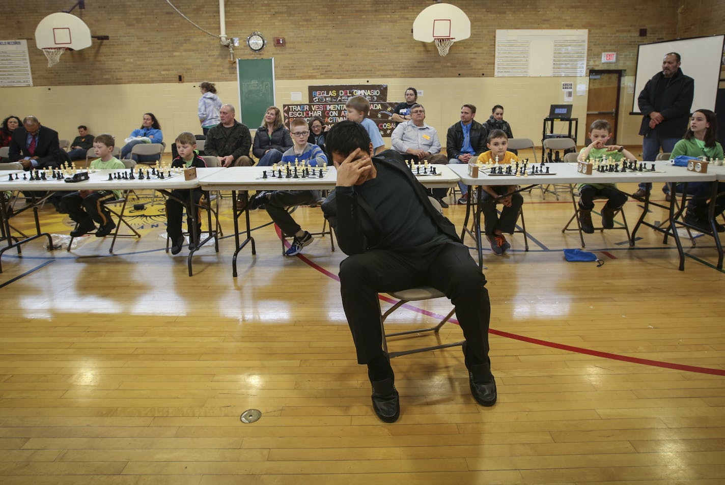 Chess Grandmaster Wesley So covered his face as he played blind chess against ten students from the chess club of Robbinsdale's Spanish Immersion School in New Hope, Minn., on Friday March 6, 2015. ] RENEE JONES SCHNEIDER &#x2022; reneejones@startribune.com