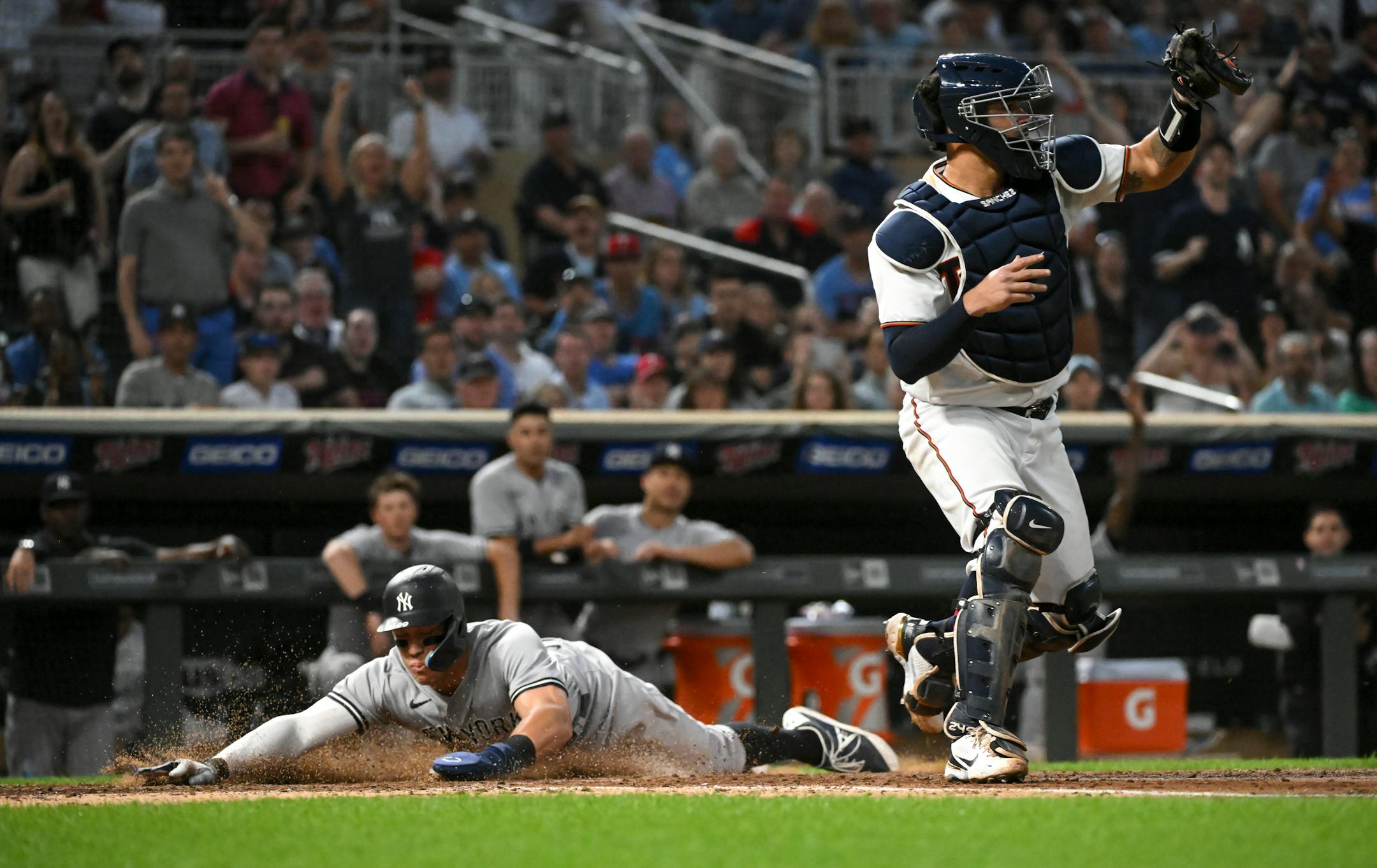 New York Yankees center fielder Aaron Judge (99) slids home safely off a single hit by first baseman Anthony Rizzo (48) in the top of the 7th inning.