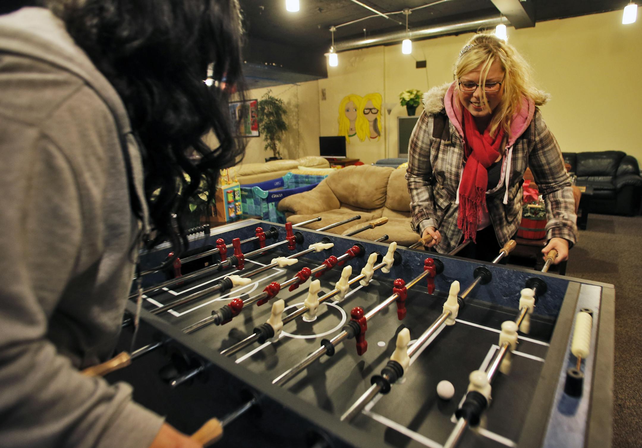 Trinity Fletcher, 20, has experience as a homeless teenager but has now found acceptance at the Hope 4 Youth drop-in center in Anoka. Trinity Fletcher, right, played a game of foosball with volunteer Tami Shinder. NOTE: WE WERE NOT ALLOWED TO PHOTOGRAPH ANY OTHER YOUTH IN THE CENTER. (MARLIN LEVISON/STARTRIBUNE(mlevison@startribune.com)