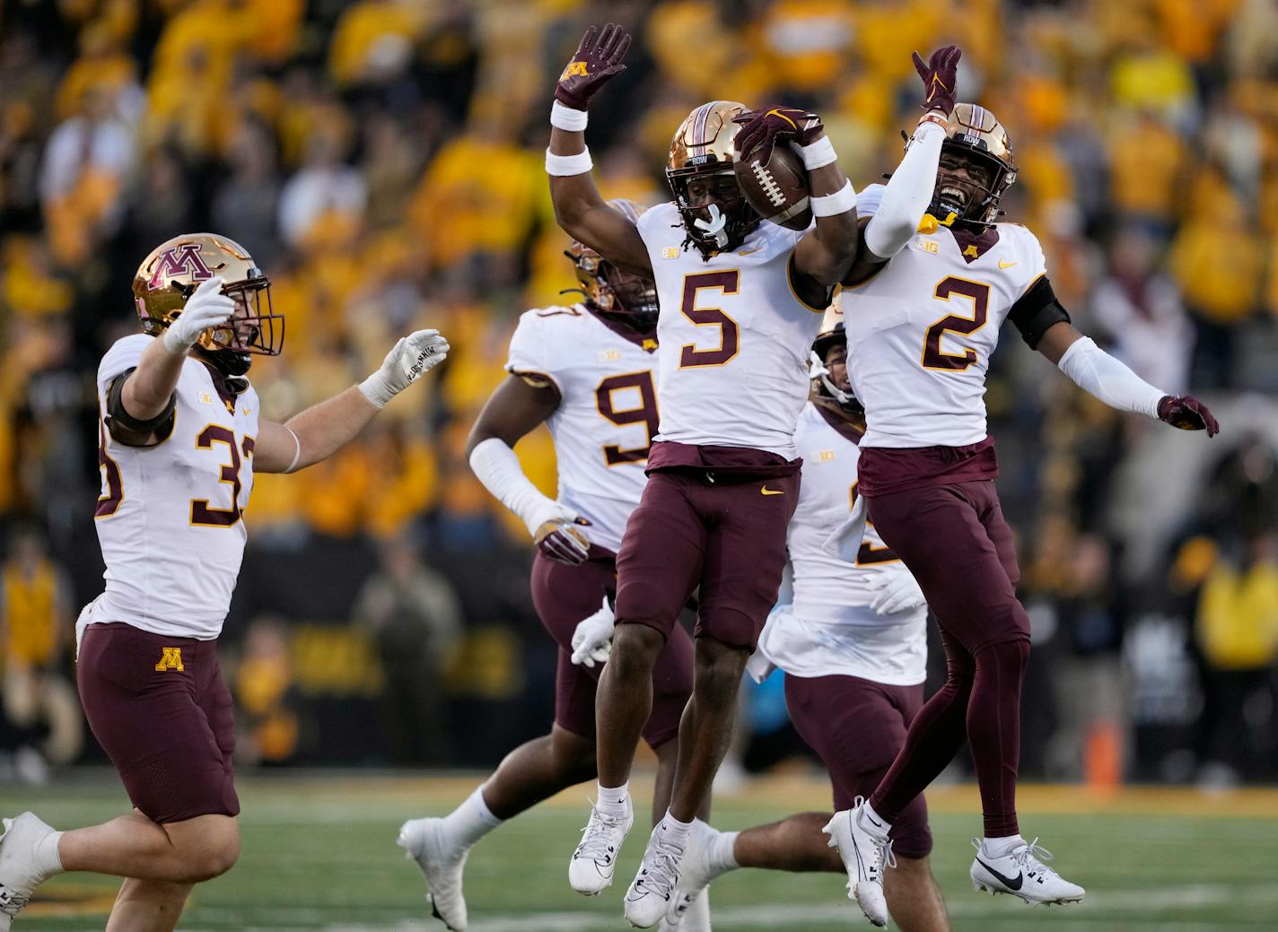 Minnesota defensive back Justin Walley (5) celebrates his interception with defensive back Tre'Von Jones (2) during the second half of an NCAA college football game against Iowa, Saturday, Oct. 21, 2023, in Iowa City, Iowa. Minnesota won 12-10. (AP Photo/Matthew Putney)