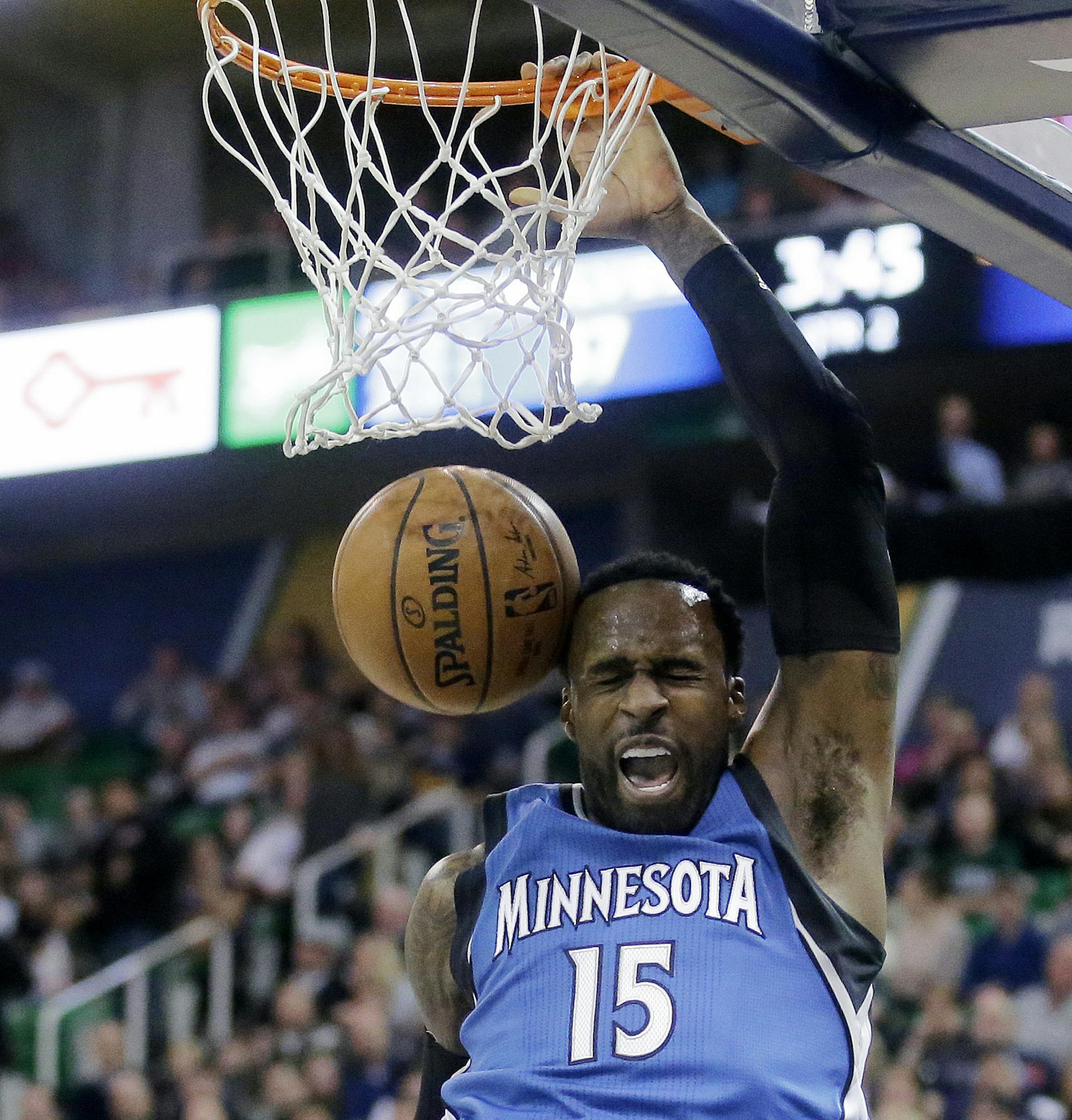 Minnesota Timberwolves forward Shabazz Muhammad (15) dunks during the first half in an NBA basketball game against the Utah Jazz, Wednesday, March 1, 2017, in Salt Lake City. (AP Photo/Rick Bowmer)