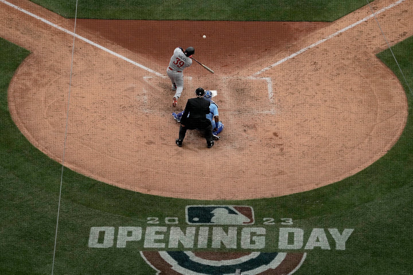 Minnesota Twins' Donovan Solano hits an RBI single during the sixth inning of an opening day baseball game against the Kansas City Royals in Kansas City, Mo., Thursday, March 30, 2023. (AP Photo/Charlie Riedel)