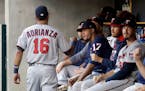 Minnesota Twins shortstop Ehire Adrianza greets teammates before the first inning of a baseball game against the Detroit Tigers, Saturday, Sept. 23, 2