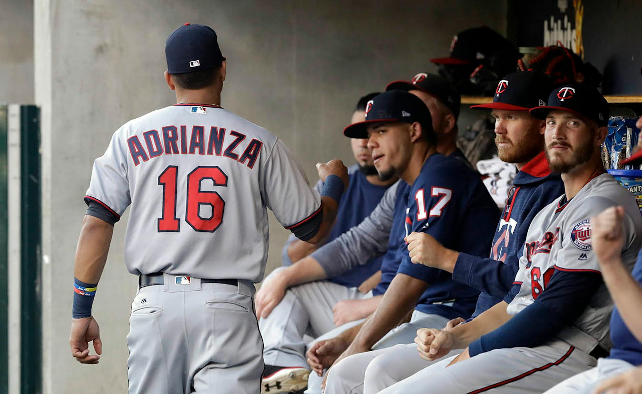 Minnesota Twins shortstop Ehire Adrianza greets teammates before the first inning of a baseball game against the Detroit Tigers, Saturday, Sept. 23, 2017, in Detroit.