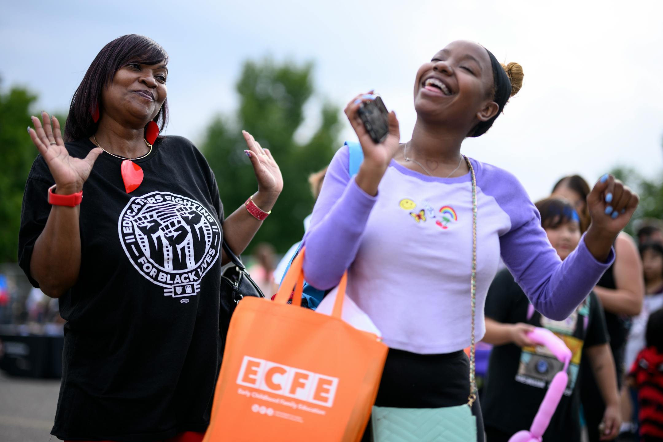 Catina Taylor, Education Support Professionals President of the Minneapolis Federation of Teachers Local 59, left, dances with parent Mook Jackson.