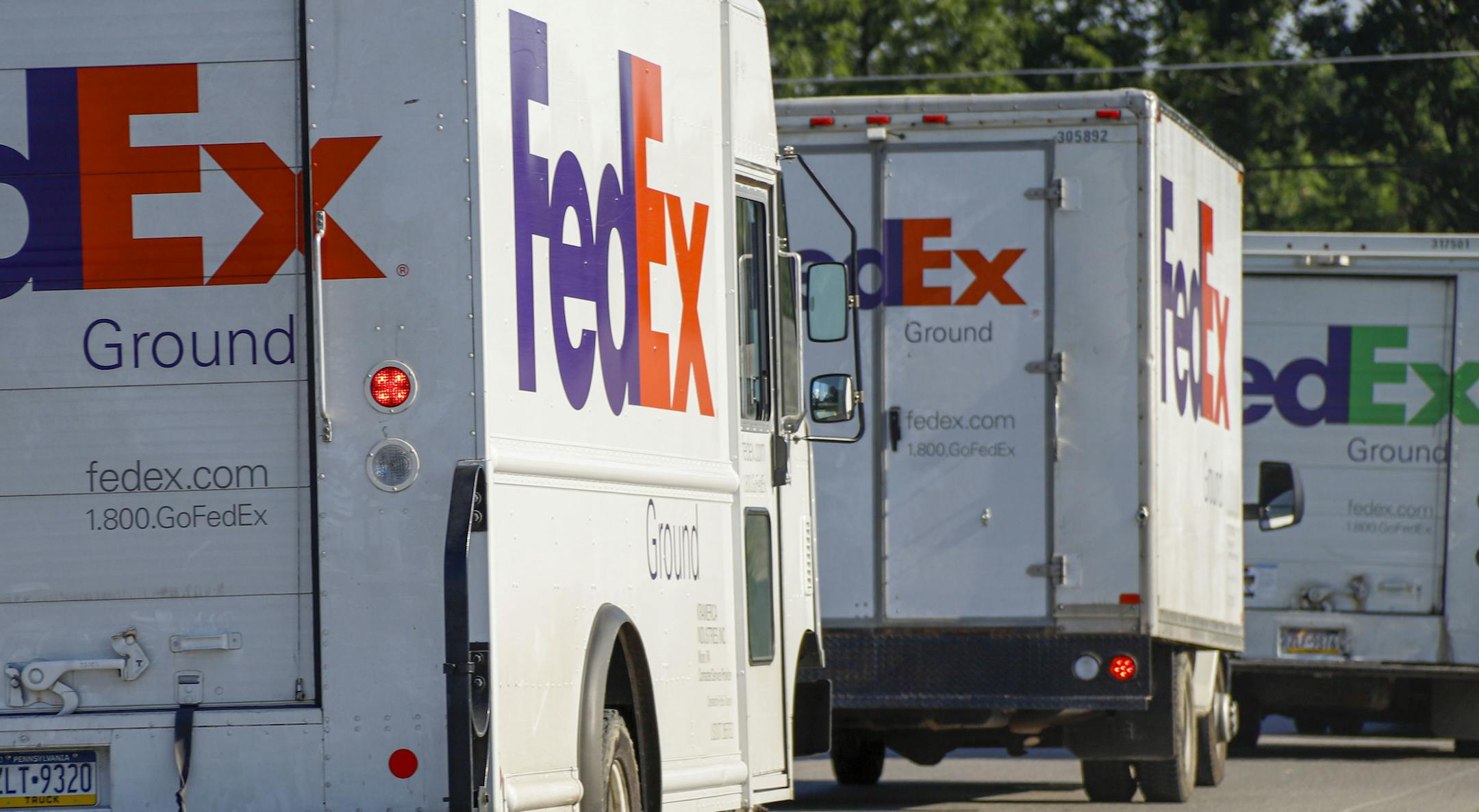 FILE - In this June 26, 2019, file photo delivery vehicles depart the FedEx Ship Center in Cranberry Township, Pa. FedEx reports earnings Tuesday, Dec. 17. (AP Photo/Keith Srakocic, File)