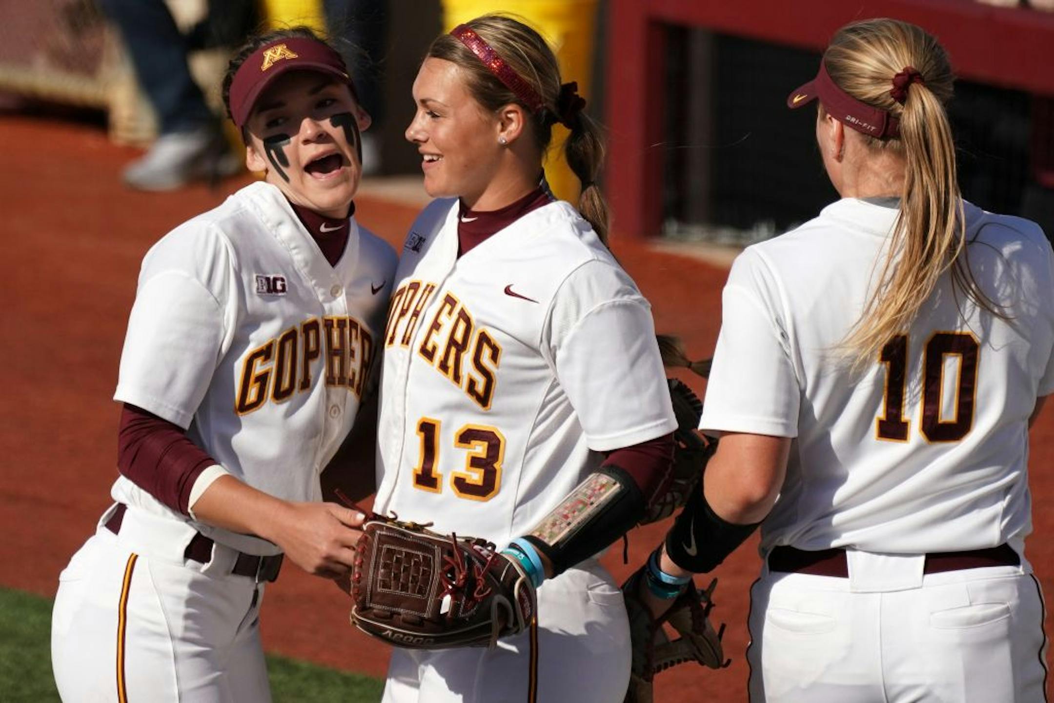 Gophers' second baseman MaKenna Partain (3) congratulated pitcher Amber Fiser (13) after getting the third out against Iowa on Friday, April 26, 2019.
