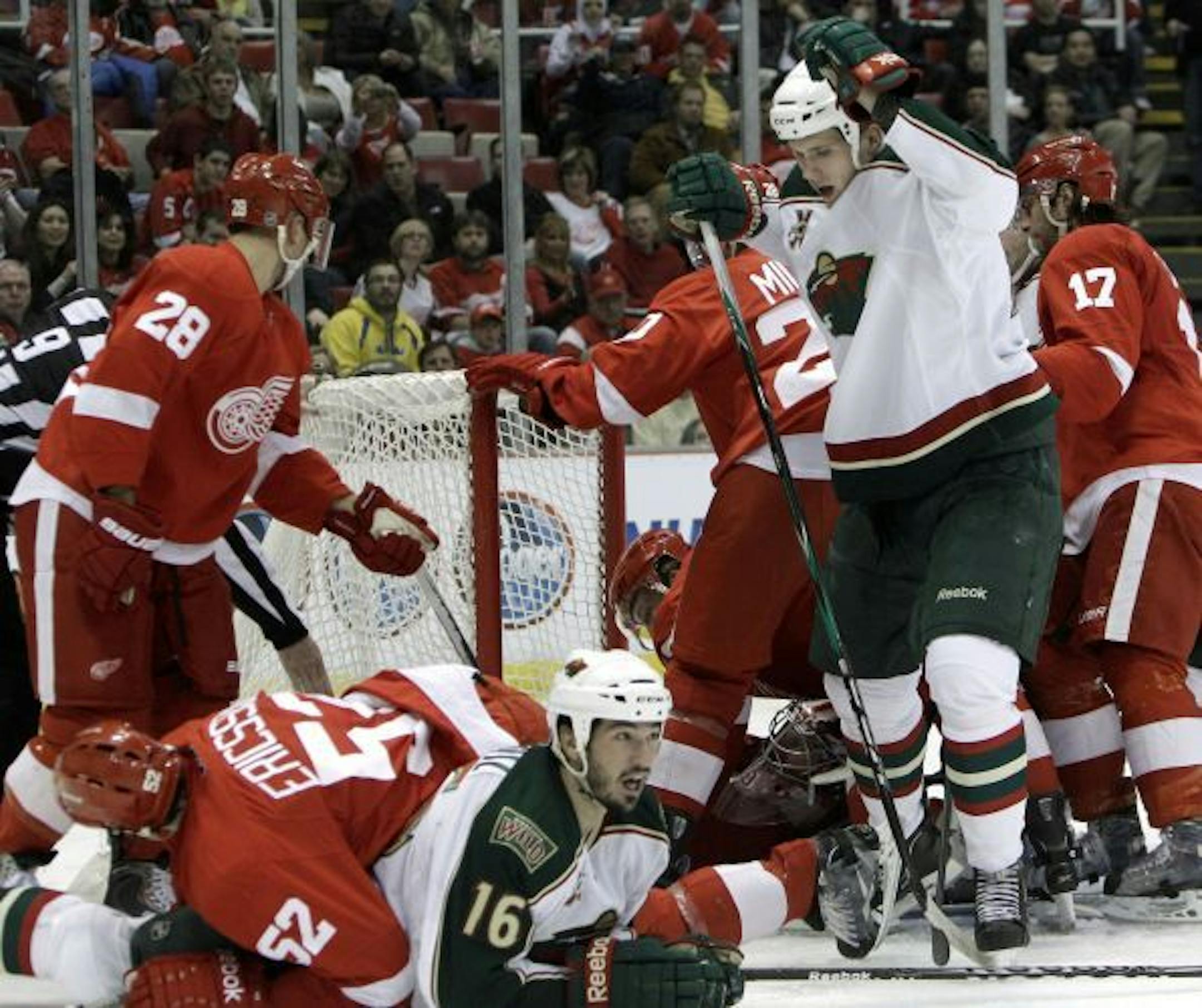 Minnesota defenseman Justin Falk, second from right, celebrated the Wild's second-period goal against the Detroit Red Wings in Detroit on Sunday.