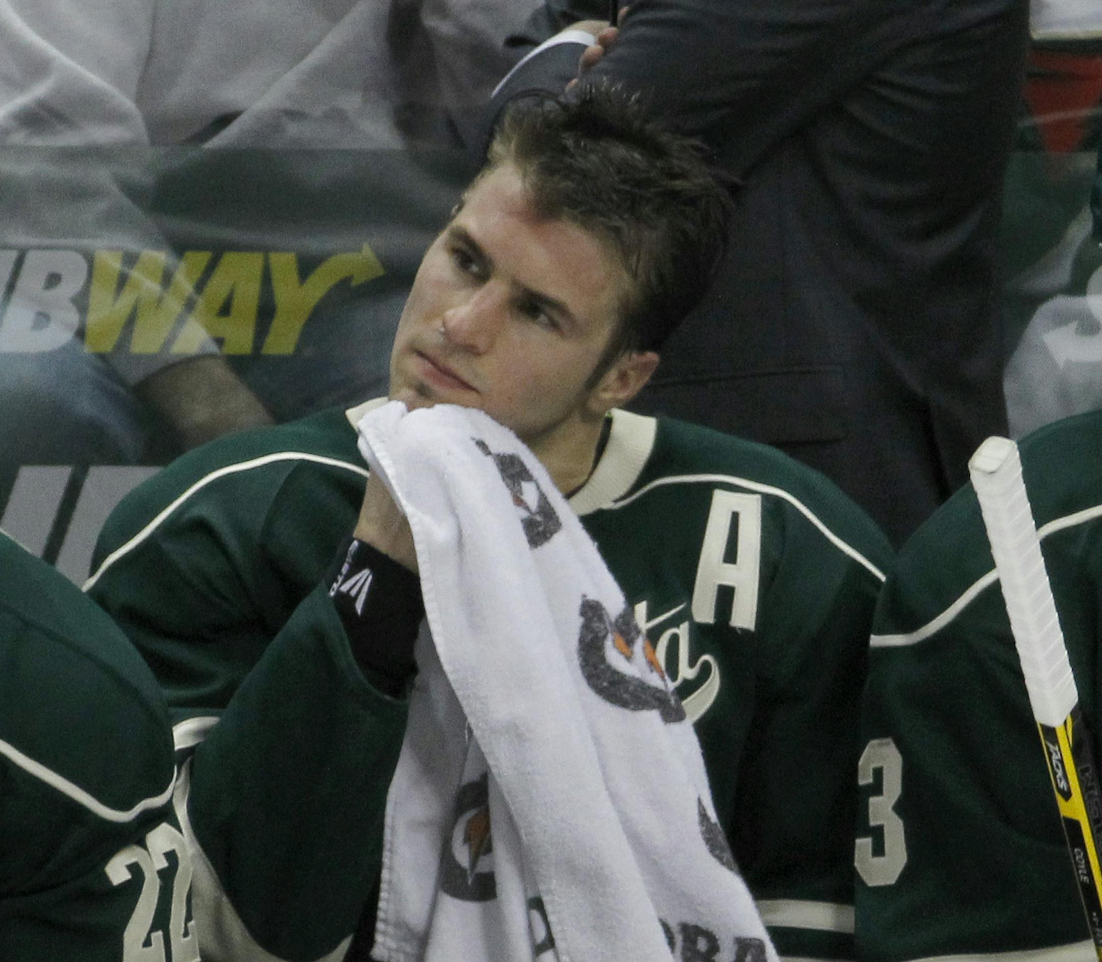 Minnesota Wild left wing Zach Parise sits between center Charlie Coyle, right, and right wing Nino Niederreiter, left, during the third period of an NHL hockey game against the Toronto Maple Leafs in St. Paul, Minn., Friday, Jan. 2, 2015. The Wild won 3-1. (AP Photo/Ann Heisenfelt)