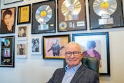 Paul Moe — chairman, CEO and co-inventor of MIIR Audio Technology, Inc. — posed for a portrait in front of records and photos of his clients — i