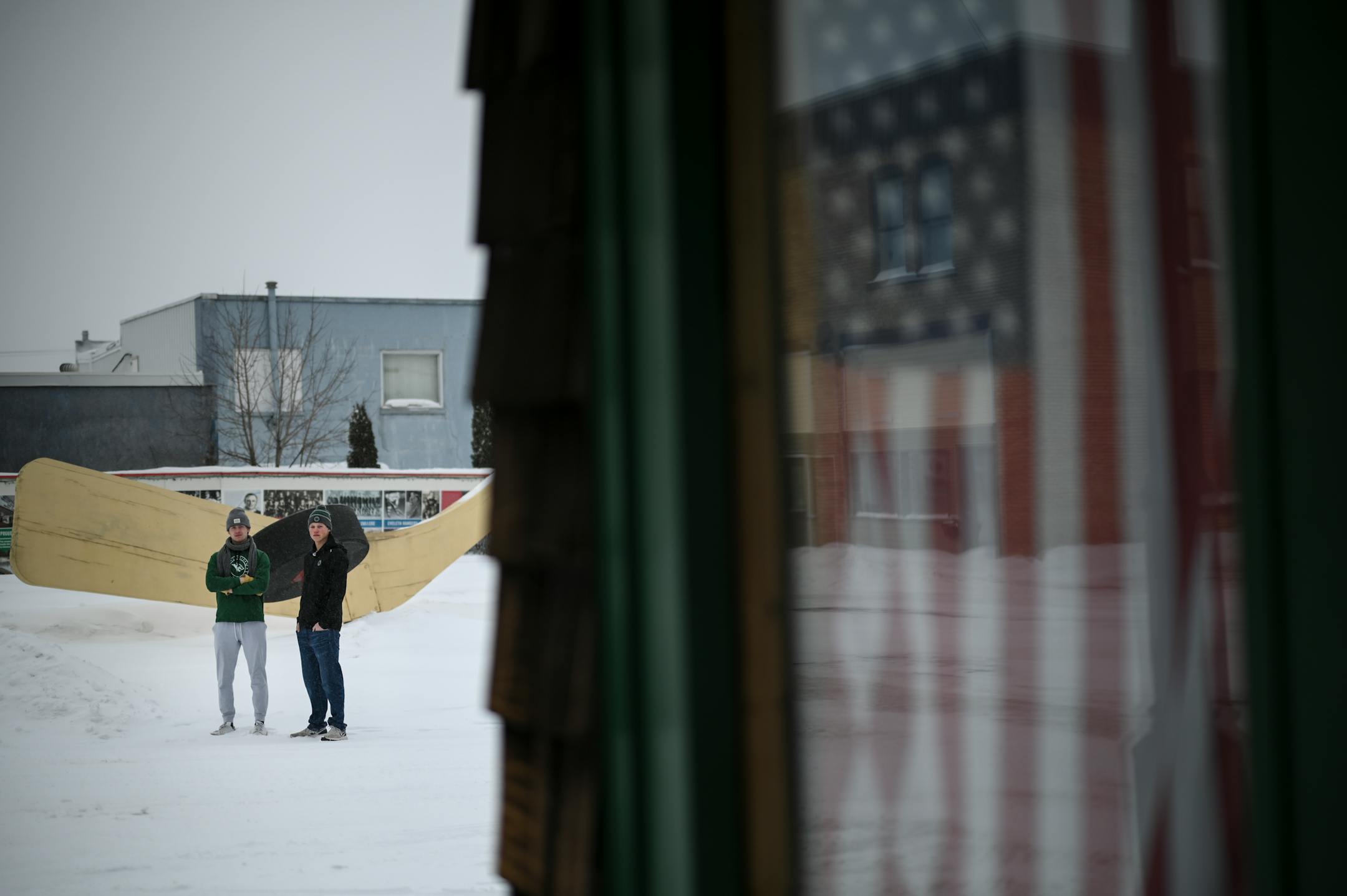 Rock Ridge's Nick Troutwine, of Eveleth, left, and Dylan Hedley, of Virginia, stand for a portrait in front of the "World's Largest Free-Standing Hockey Stick," Tuesday, Feb. 22, 2022 in Eveleth, Minn.