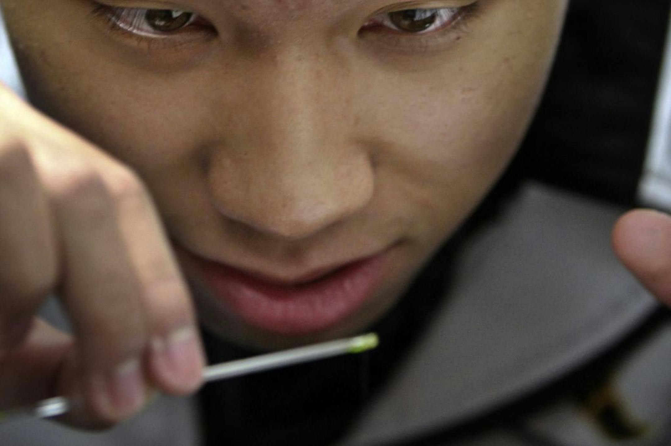 Burnsville High School junior Alex Chantara studied the movement of liquid into a glass tube during an experiment to simulate capillary action at Dakota County Technical College in Rosemount last week. High school students from Burnsville and Farmington are taking a one-of-a-kind course in nanotechnology aimed at teaching them about the science and application of a cutting-edge field.