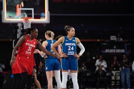 Lynx forward Napheesa Collier stands during a break in the action Sunday in Atlanta. At left is Dream veteran Tina Charles.