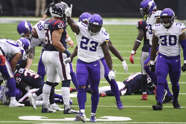 Minnesota Vikings running back Mike Boone (23) celebrates a fumble recovery during the first half of an NFL football game against the Houston Texans, 