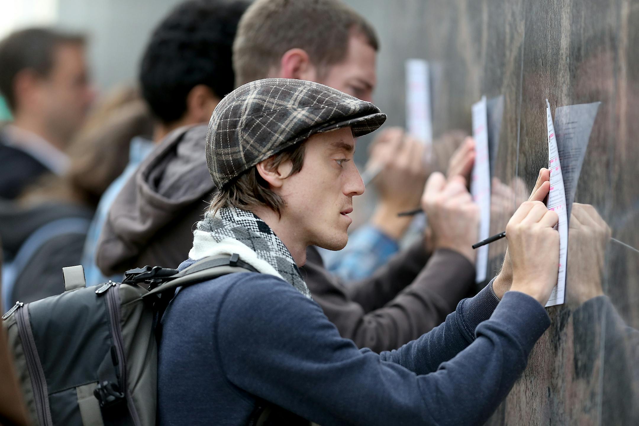 Voters including Justin Munro found a wall outside the Community Services Building to fill out voter registration forms during the last day to vote early, Monday, November 7, 2016 in Minneapolis, MN.