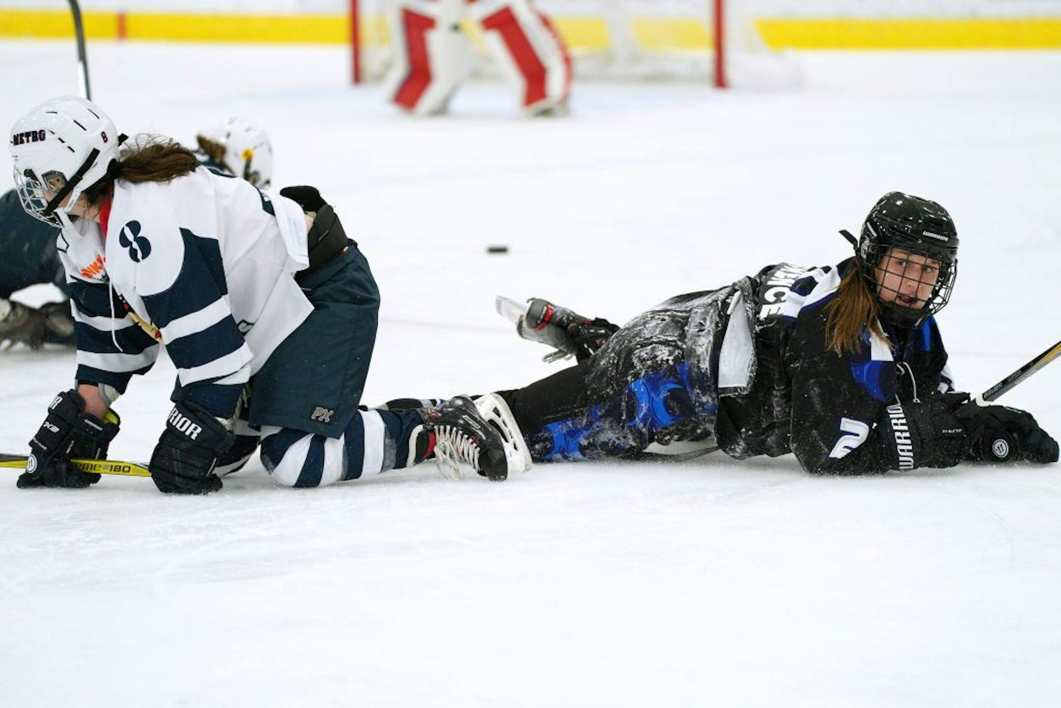 Whitecaps forward Meghan Lorence (20) looked up after she collided with Riveters defenseman Colleen Murphy (8) during Saturday's game.