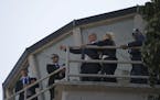 Israeli Prime Minister Benjamin Netanyahu and his wife, Sara, stand on the control tower at the old Entebbe airport, still bearing bullet holes, durin