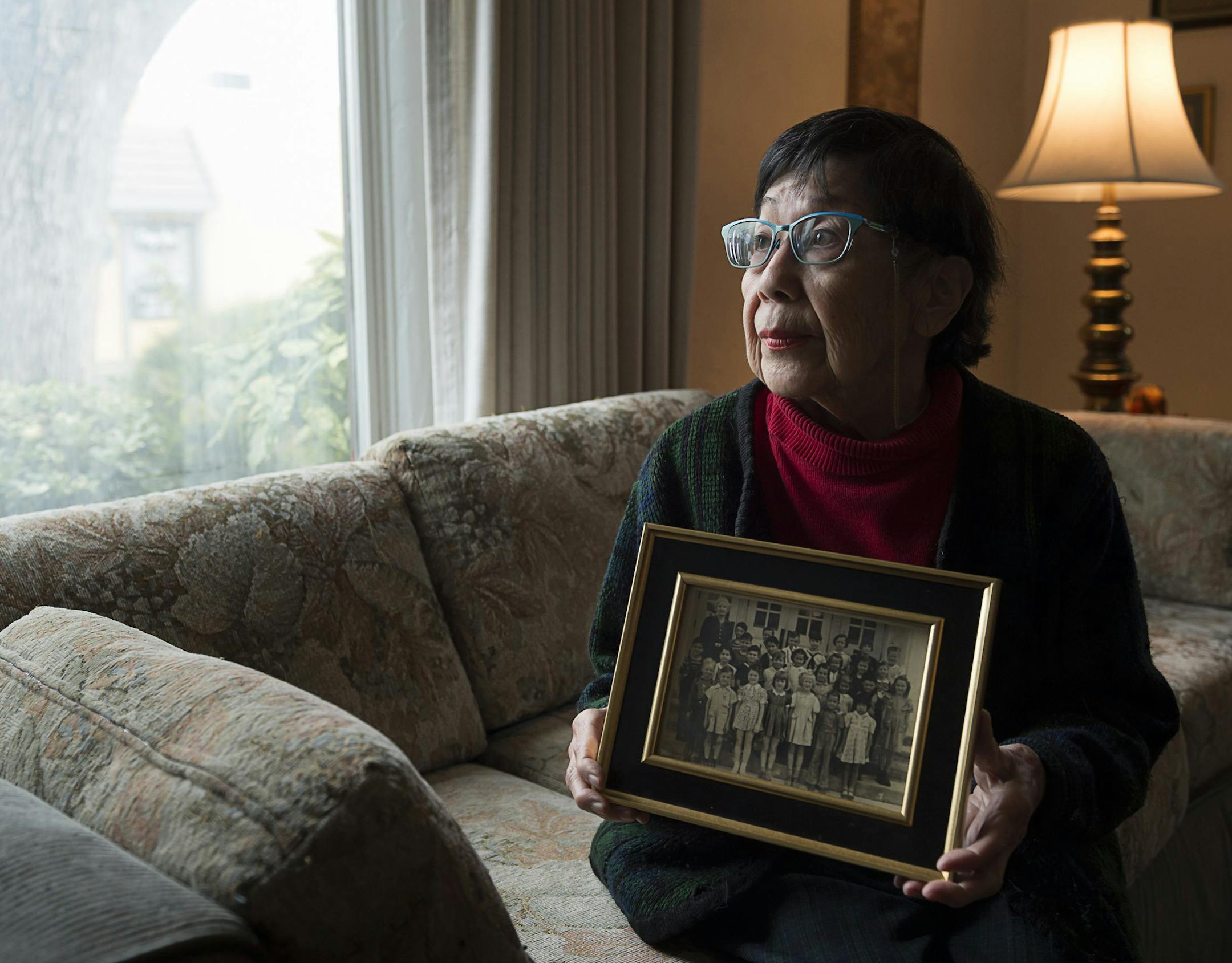Reiko Nagumo holds her Los Feliz Elementary School first grade school photo at her home in Sacramento, Calif. on Monday Jan. 22, 2018. Reiko reunited with her classmate Mary Frances after 72 years in 2017. (Paul Kitagaki Jr./Sacramento Bee/TNS)