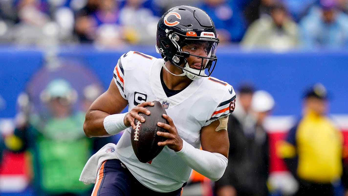 Chicago Bears quarterback Justin Fields (1) looks to pass against the New York Giants during the first quarter of an NFL football game, Sunday, Oct. 2, 2022, in East Rutherford, N.J. (AP Photo/John Minchillo)