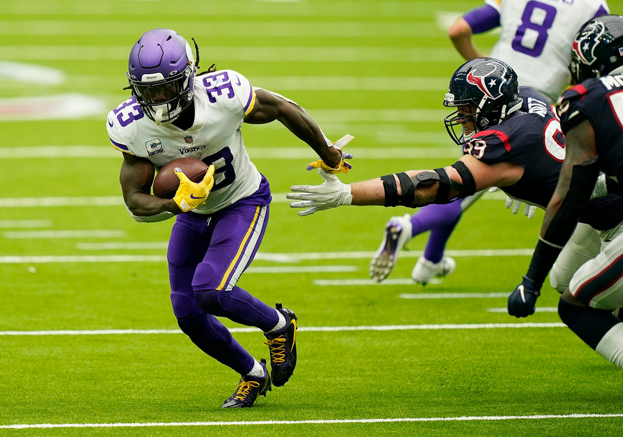 Minnesota Vikings running back Dalvin Cook (33) breaks away from Houston Texans defensive end J.J. Watt (99) during the second half of an NFL football game Sunday, Oct. 4, 2020, in Houston. (AP Photo/David J. Phillip)