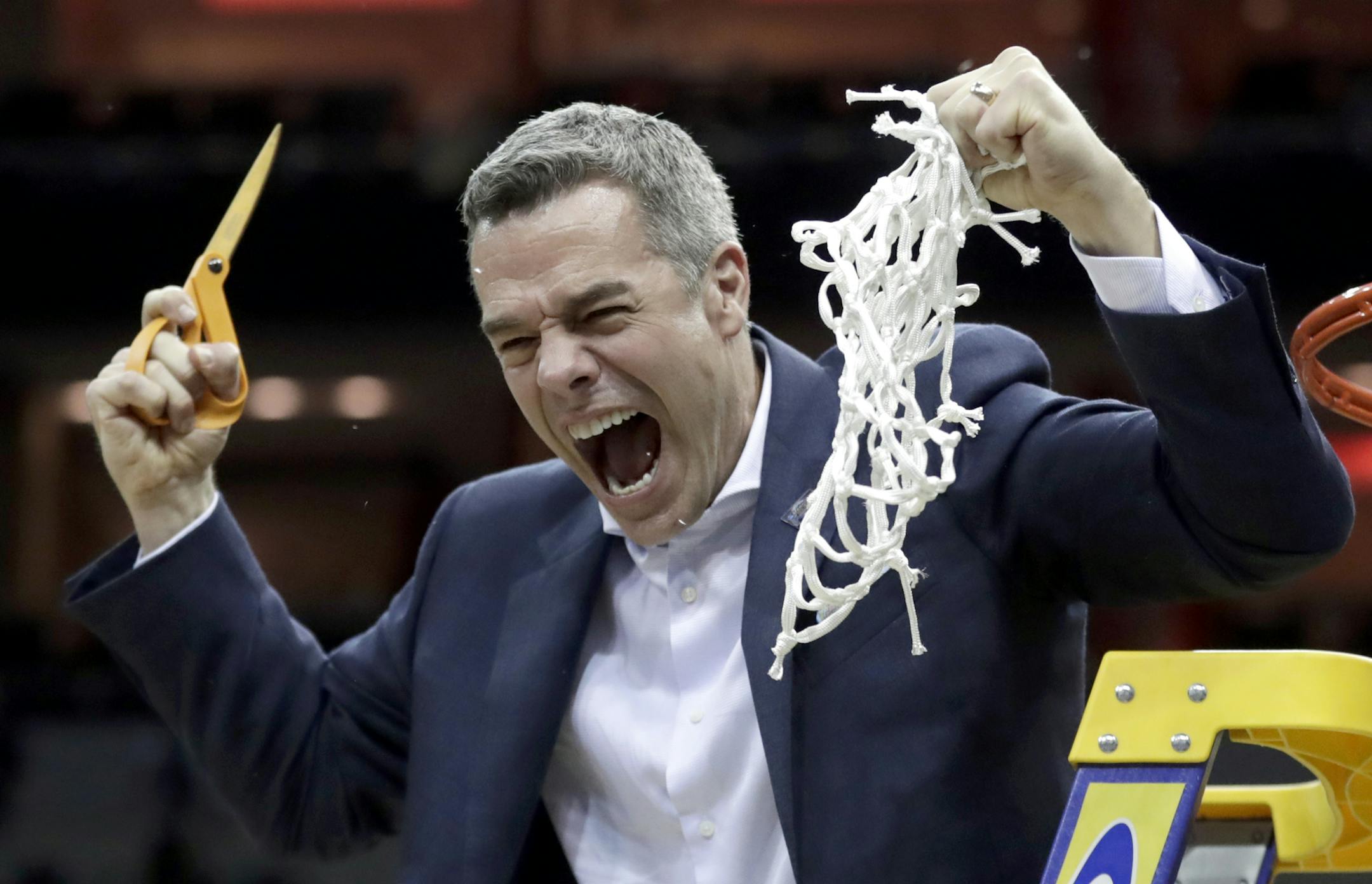 Virginia head coach Tony Bennett celebrates after defeating Purdue 80-75 in overtime