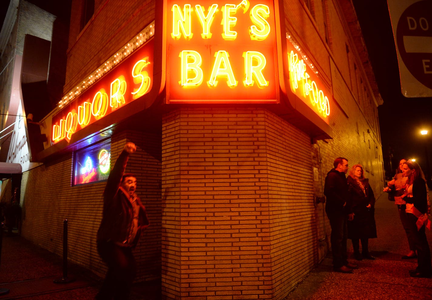 Nye's patrons congregated outside for a smoke break. The original corner bar, which dates to the 1880s, will be preserved -- but not Nye's itself -- in a new six-story apartment and retail complex.