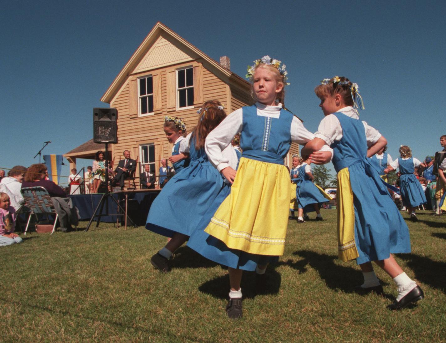 -- dance.3269,- children in folk dress - the Kichi-Saga Junior Dancers danced in for the King and Queen as they sat in front of the restored farmhouse -the Nya Duvemala- the ficticious home of Karl Oskar in a Moberg story- near Lindstrom MN