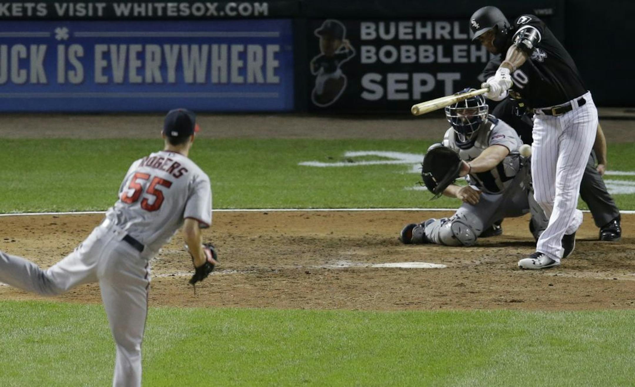Chicago White Sox's Yoan Moncada hits an RBI double off Minnesota Twins relief pitcher Taylor Rogers during the eighth inning of a baseball game Wednesday, Aug. 23, 2017, in Chicago.